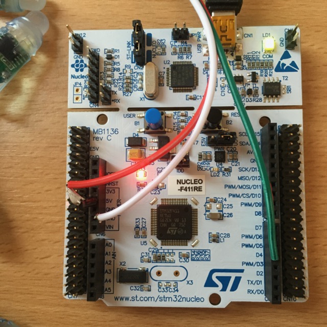 Close up of the Nuclue board showing three wires: one to power, one to ground, one to a control pin