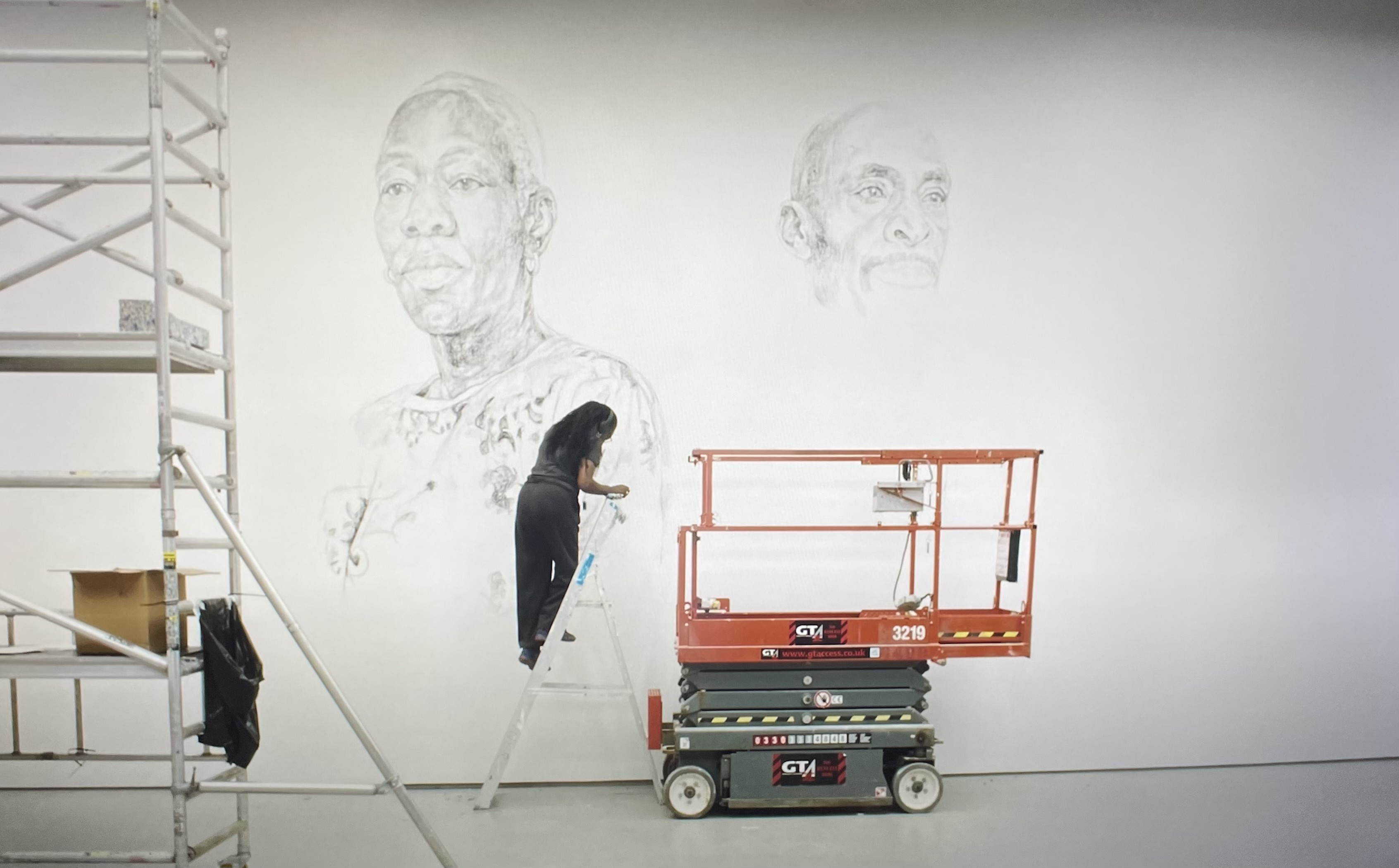 Still from an introduction video showing the artist creating the work. “These drawings will be washed away by the artist at the end of the exhibition […]”