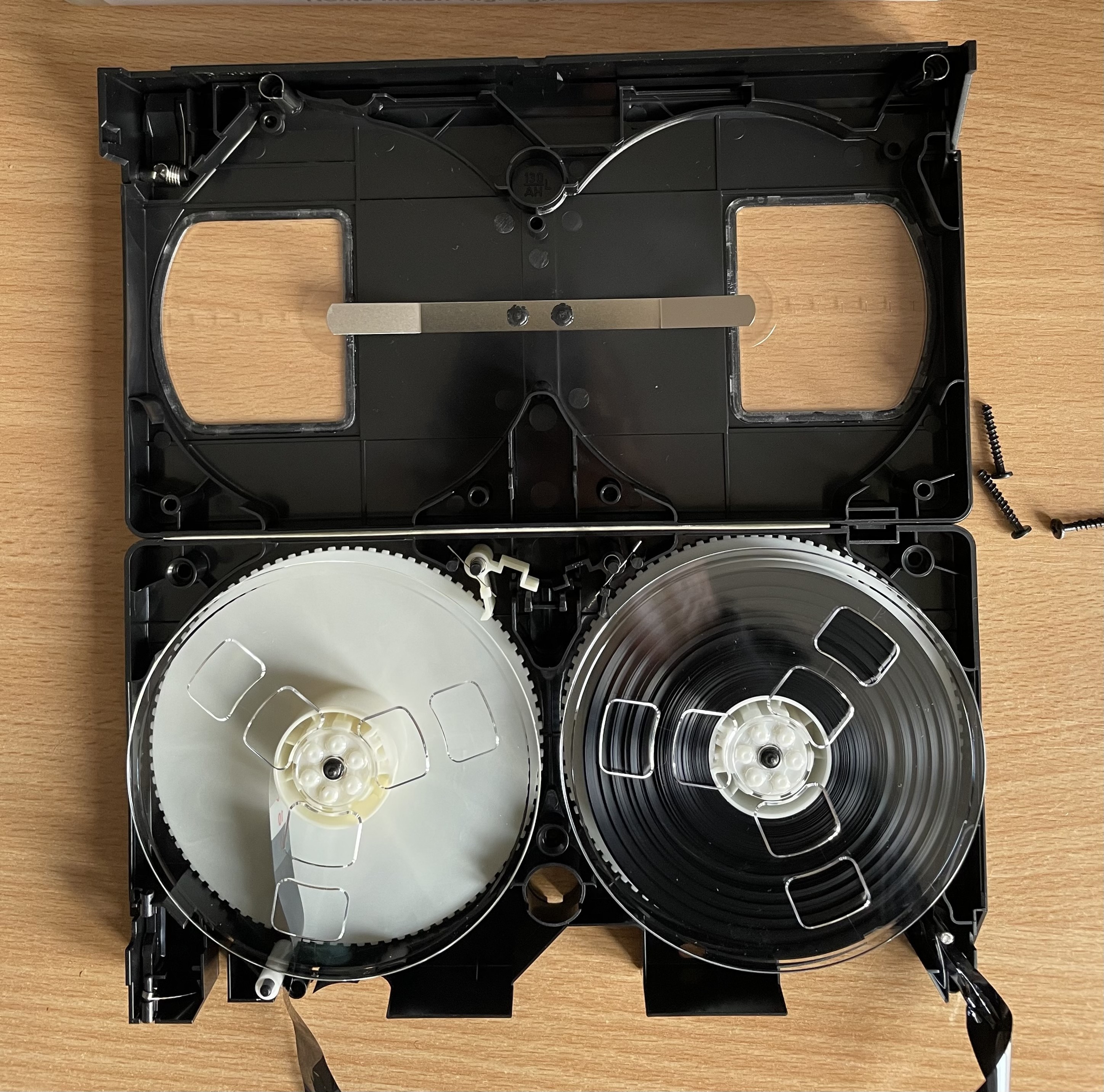 The inside of a VHS tape, showing two reels of tape.